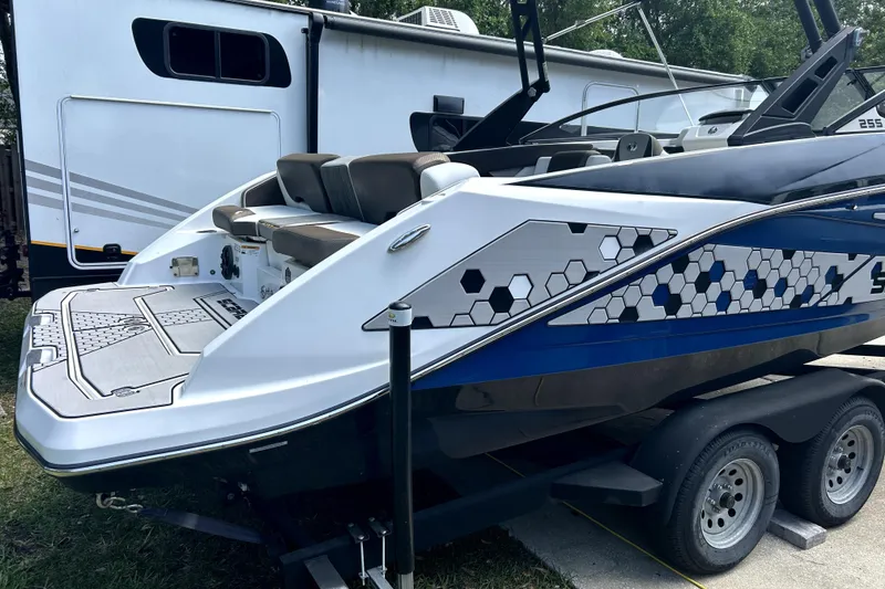 Slide: The Image of 2020 Scarab 255 ID boat on trailer, featuring hexagonal pattern design. - 3