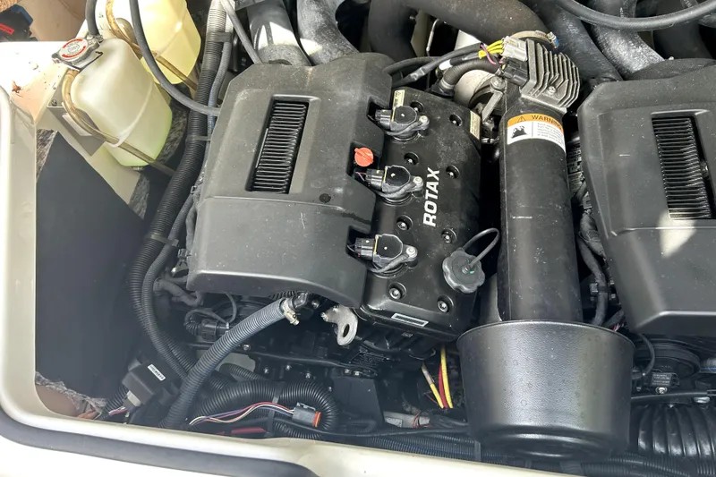 Slide: The Image of Engine compartment of a 2020 Scarab 255 ID with Rotax engine components. - 31