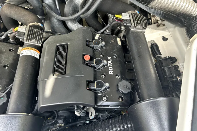 Slide: The Image of Engine compartment of a 2020 Scarab 255 ID with Rotax motor components. - 32