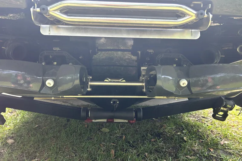 Slide: The Image of Rear view of a 2020 Scarab 255 ID boat's propulsion system on grass. - 34