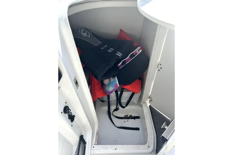 Slide: The Image of Storage compartment in 2020 Scarab 255 ID boat with life jackets and gear. - 41