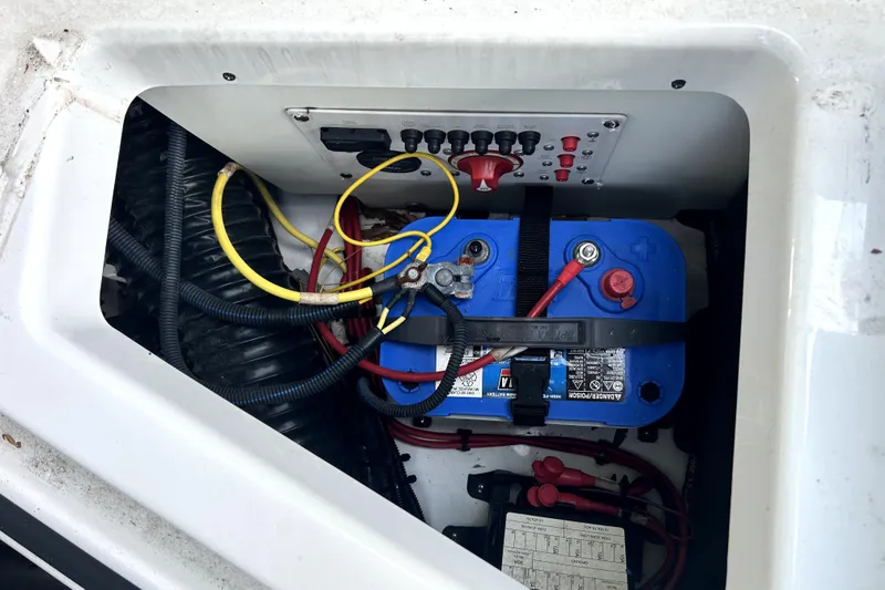 Slide: The Image of Battery compartment of a 2020 Scarab 255 ID boat with wiring and control panel. - 42
