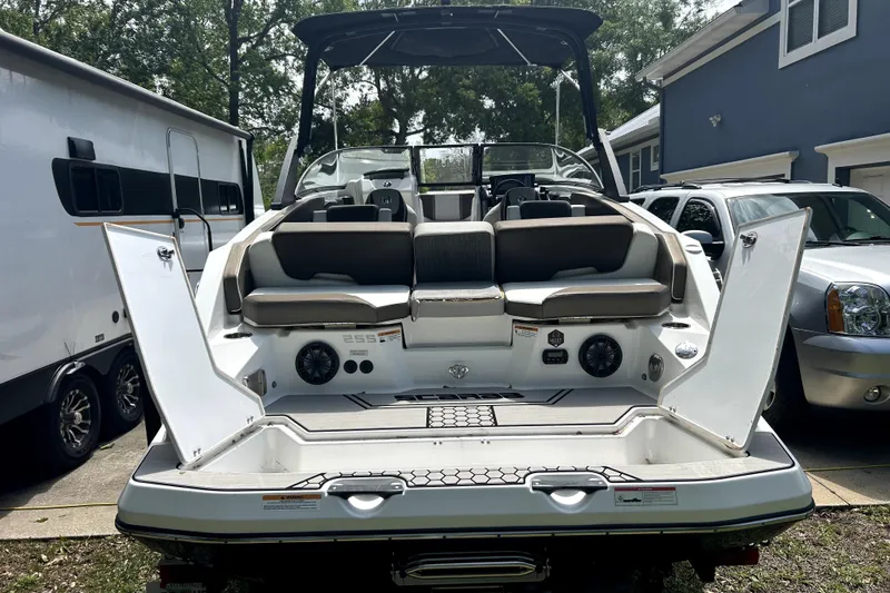 Slide: The Image of 2020 Scarab 255 ID boat with open rear seating and storage compartments. - 6