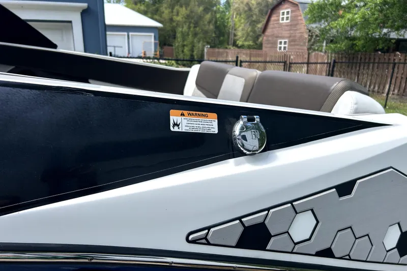 Slide: The Image of 2020 Scarab 255 ID boat detail with warning label and hexagonal design. - 8