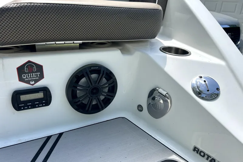 Slide: The Image of 2020 Scarab 255 ID boat interior with speaker, control panel, and Quiet Performance sticker. - 9