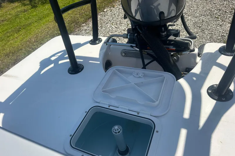 Slide: The Image of 2026 Delta Boatworks Delta D18 with open storage compartment and visible engine components. - 12