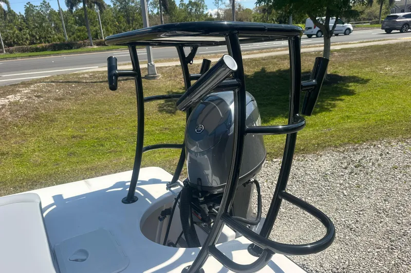 Slide: The Image of 2026 Delta Boatworks Delta D18 with outboard motor and rod holders, parked outdoors. - 15