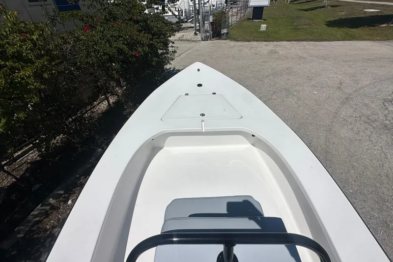 Slide: The Image of 2026 Delta Boatworks Delta D18, sleek white deck, parked outdoors. - 16