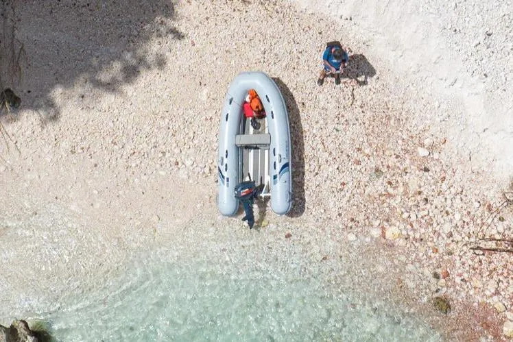 Slide: The Image of Manufacturer Provided Image: Aerial view of 2025 Highfield Ultralite 240 inflatable boat on a rocky beach. - 3