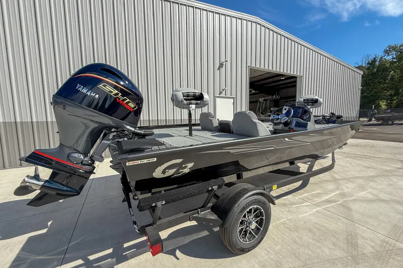 Slide: The Image of 2026 G3 Sportsman 1810 boat with Yamaha engine, parked outside a metal building. - 4