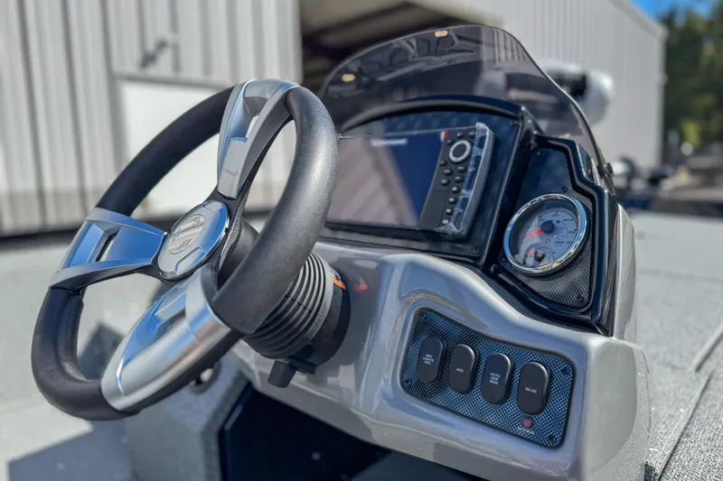 Slide: The Image of 2026 G3 Sportsman 1810 boat dashboard with steering wheel and control panel. - 6
