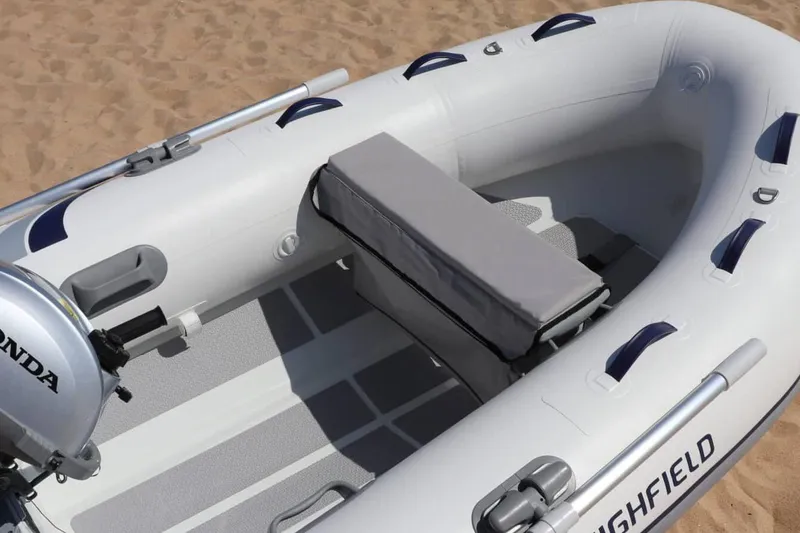 Slide: The Image of Manufacturer Provided Image: 2025 Highfield UltraLite 260 inflatable boat on sandy beach. - 2