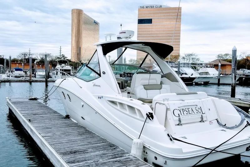 Slide: The Image of 2007 Sea Ray Sundancer 310 yacht docked at marina, showcasing sleek design and luxury features. - 3