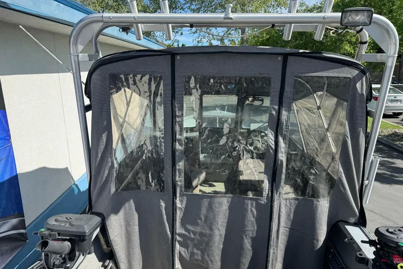 Slide: The Image of 2006 Alumaweld Stryker Sport 19 boat with covered cockpit and fishing equipment. - 11