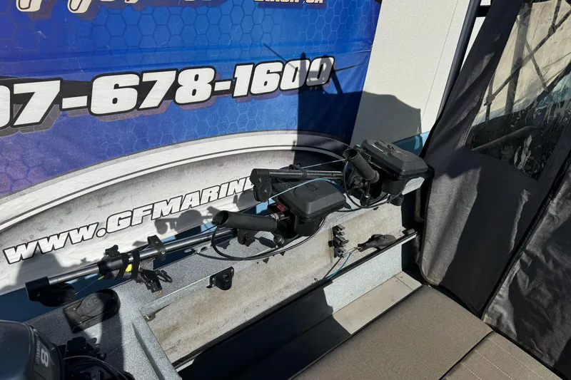 Slide: The Image of 2006 Alumaweld Stryker Sport 19 boat interior with fishing equipment and contact information. - 13
