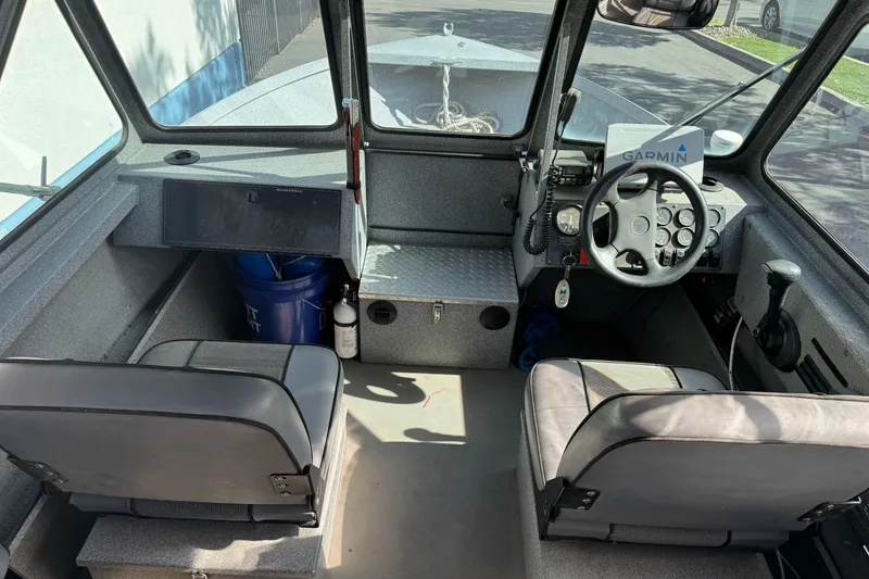 Slide: The Image of 2006 Alumaweld Stryker Sport 19 boat interior with steering wheel and seating. - 17