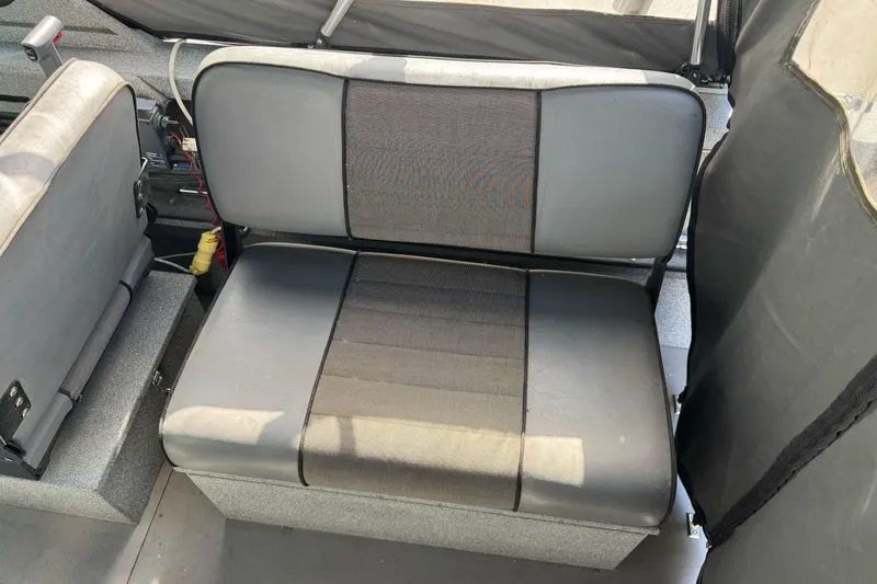 Slide: The Image of 2006 Alumaweld Stryker Sport 19 boat interior seating, featuring gray and black upholstery. - 18