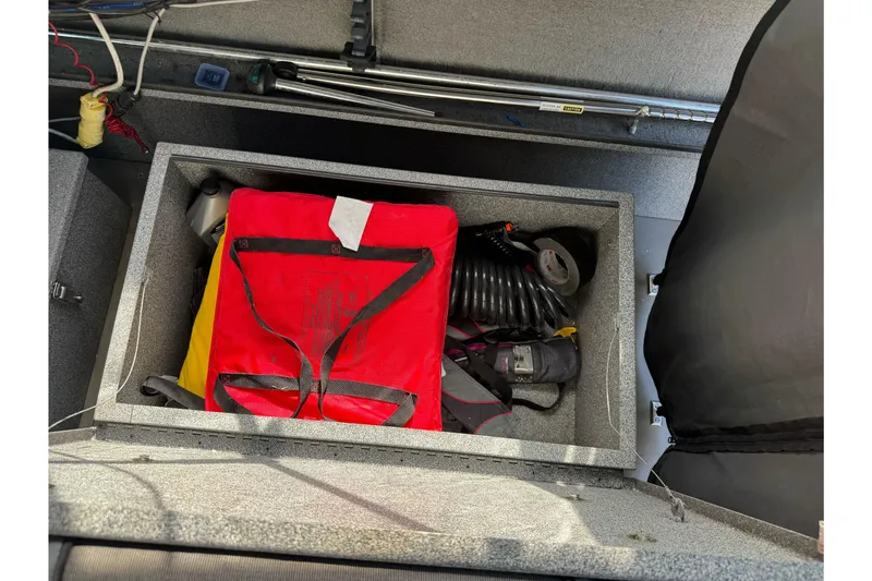 Slide: The Image of Storage compartment of a 2006 Alumaweld Stryker Sport 19 boat with safety gear. - 20