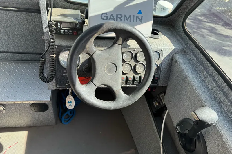 Slide: The Image of 2006 Alumaweld Stryker Sport 19 boat dashboard with Garmin GPS and control panel. - 22