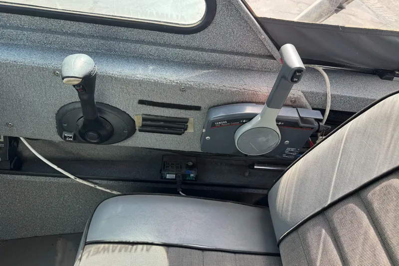 Slide: The Image of 2006 Alumaweld Stryker Sport 19 boat interior with control panel and steering. - 23