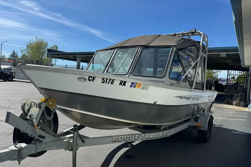 Slide: The Image of 2006 Alumaweld Stryker Sport 19 boat on Rogue trailer in parking lot. - 6