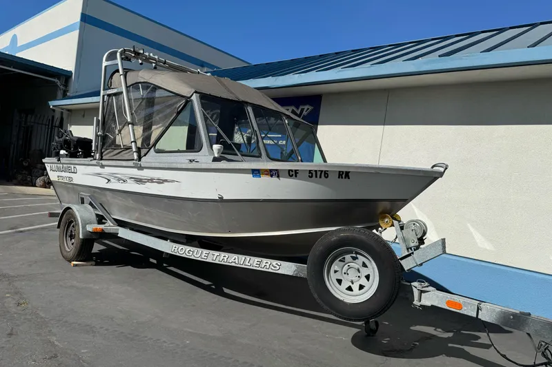 Slide: The Image of 2006 Alumaweld Stryker Sport 19 boat on Rogue trailer, parked outdoors. - 7