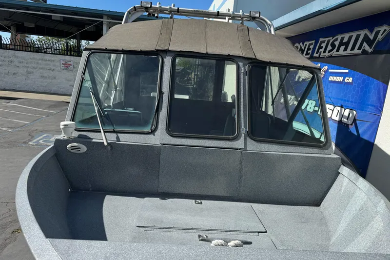 Slide: The Image of 2006 Alumaweld Stryker Sport 19 boat with covered cabin, parked outdoors. - 9