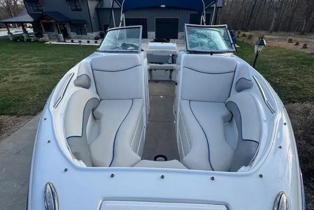 Slide: The Image of 2013 Rinker 246 Captiva Bowrider with spacious seating, white upholstery, and open bow design. - 13