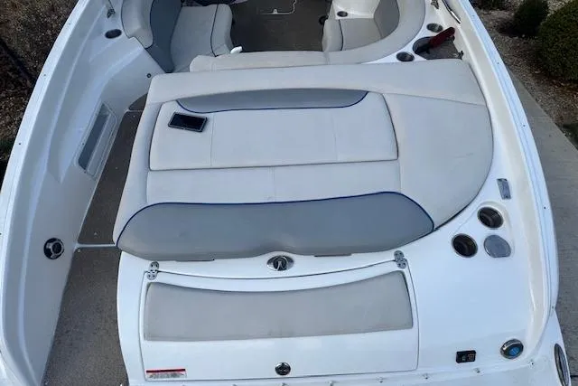 Slide: The Image of 2013 Rinker 246 Captiva Bowrider interior with white and gray seating. - 15