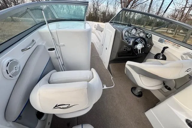Slide: The Image of 2013 Rinker 246 Captiva Bowrider interior with white seating and dashboard view. - 19