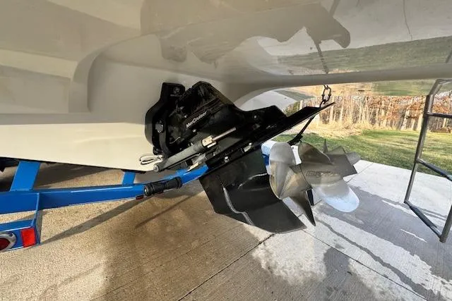 Slide: The Image of 2013 Rinker 246 Captiva Bowrider boat on trailer, showing propeller and outdrive. - 20