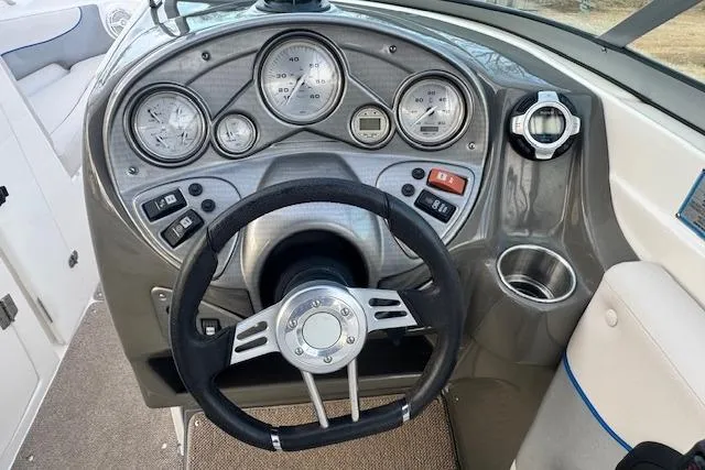 Slide: The Image of 2013 Rinker 246 Captiva Bowrider dashboard with steering wheel and gauges. - 24