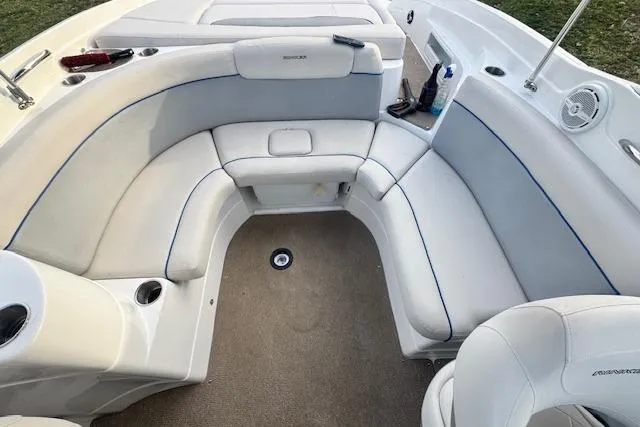 Slide: The Image of 2013 Rinker 246 Captiva Bowrider interior with white seating and cup holders. - 27