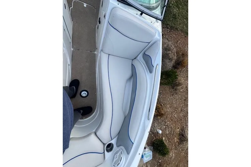Slide: The Image of 2013 Rinker 246 Captiva Bowrider interior with white seating and blue accents. - 31