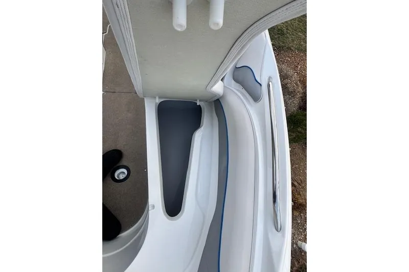 Slide: The Image of 2013 Rinker 246 Captiva Bowrider interior detail with seating and storage compartment. - 34