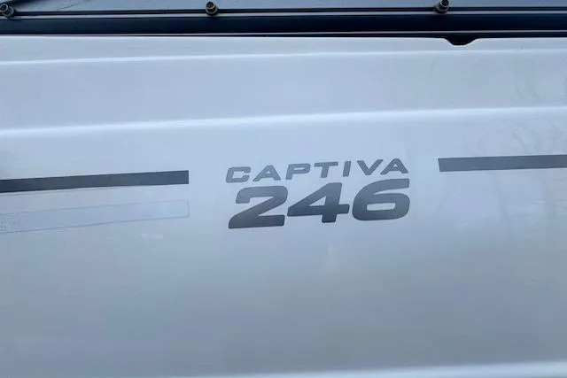 Slide: The Image of 2013 Rinker 246 Captiva Bowrider boat logo on white surface. - 37