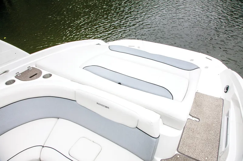 Slide: The Image of Manufacturer Provided Image: 2013 Rinker Captiva 246 BR boat with white and gray seating, near water. - 41