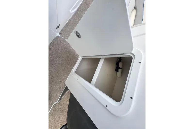 Slide: The Image of Open storage compartment on 2013 Rinker 246 Captiva Bowrider boat. - 43