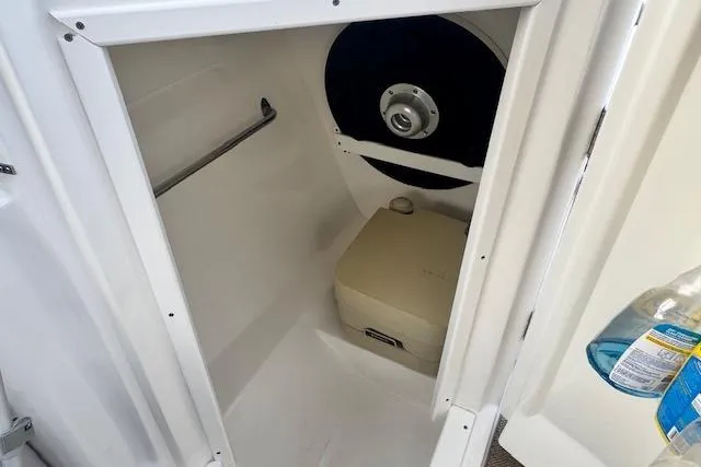 Slide: The Image of Interior of 2013 Rinker 246 Captiva Bowrider showing compact marine toilet. - 44