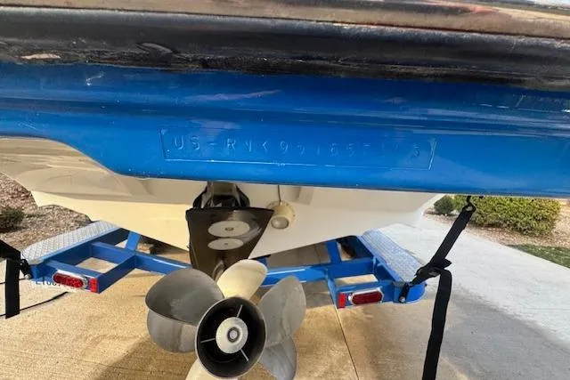 Slide: The Image of 2013 Rinker 246 Captiva Bowrider on trailer, showing propeller and hull identification number. - 45