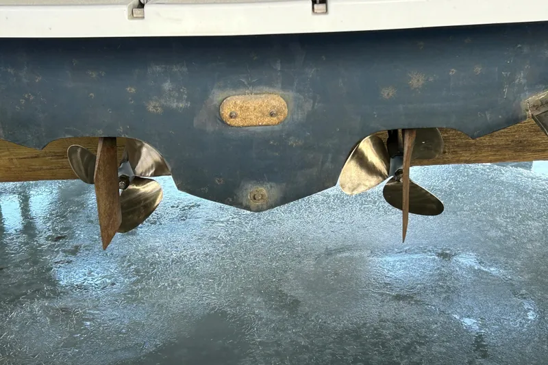 Slide: The Image of Propellers of a 1991 Sea Ray 400 Express Cruiser on a wet surface. - 12