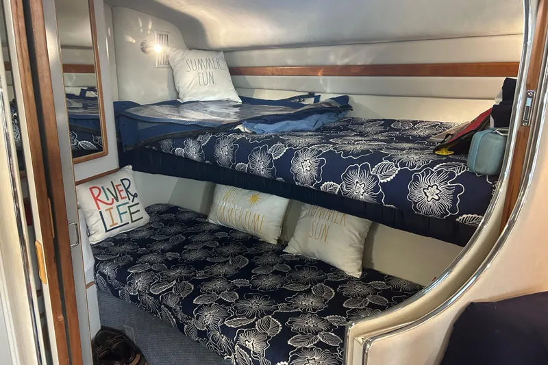 Slide: The Image of Interior of 1991 Sea Ray 400 Express Cruiser with cozy bunk beds and nautical decor. - 6