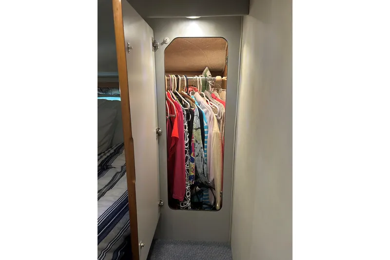 Slide: The Image of Closet with clothes inside a 1991 Sea Ray 400 Express Cruiser yacht. - 7
