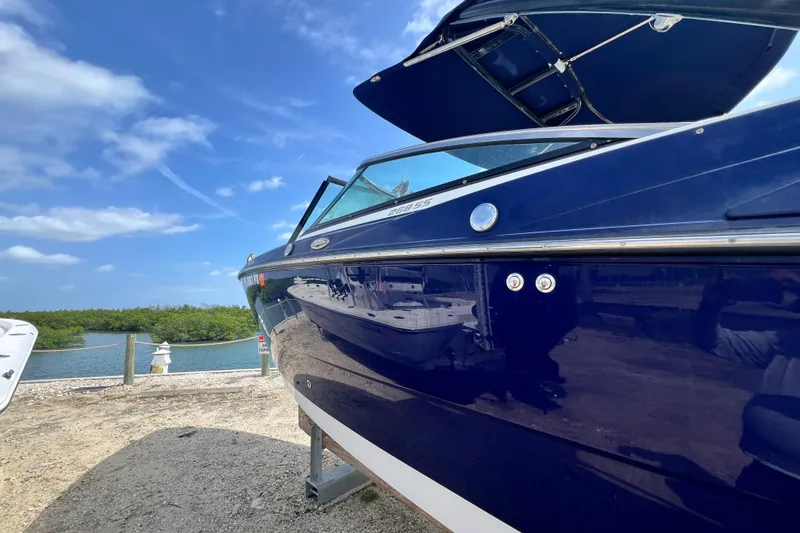 Slide: The Image of 2015 Monterey 268SS Super Sport boat docked by a scenic waterfront. - 10