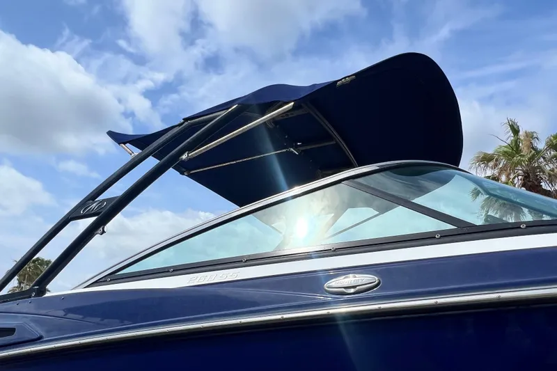 Slide: The Image of 2015 Monterey 268SS Super Sport boat with blue canopy under a sunny sky. - 12