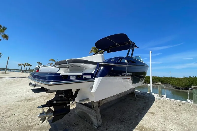 Slide: The Image of 2015 Monterey 268SS Super Sport boat on a sunny day by the water. - 2