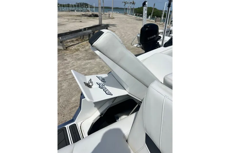 Slide: The Image of 2015 Monterey 268SS Super Sport boat interior with white seating and storage compartment. - 32