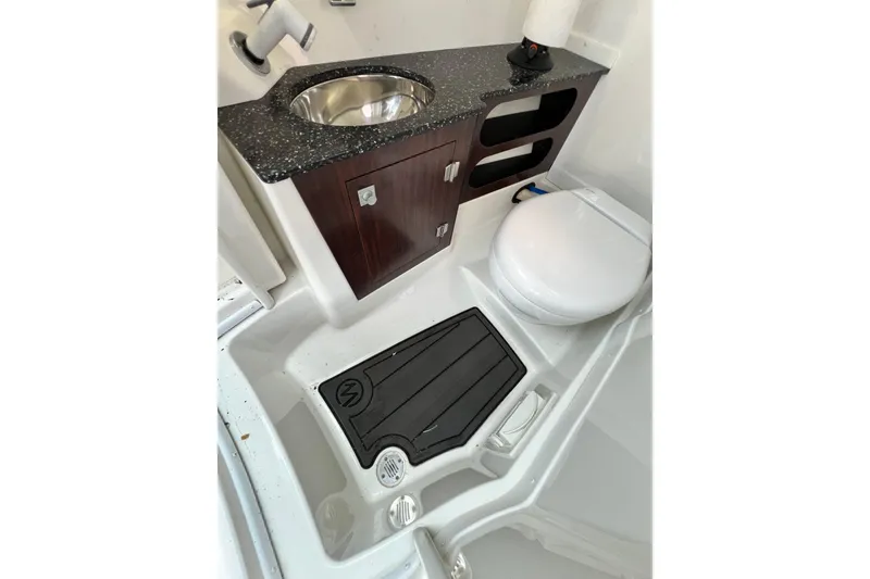 Slide: The Image of 2015 Monterey 268SS Super Sport boat bathroom with sink, toilet, and storage cabinet. - 42