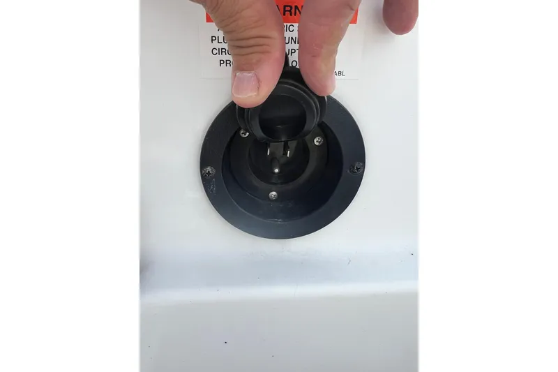 Slide: The Image of Close-up of a hand adjusting a plug on a 2015 Monterey 268SS Super Sport boat. - 44