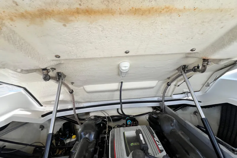 Slide: The Image of Engine compartment of a 2015 Monterey 268SS Super Sport boat, showing mechanical components. - 59
